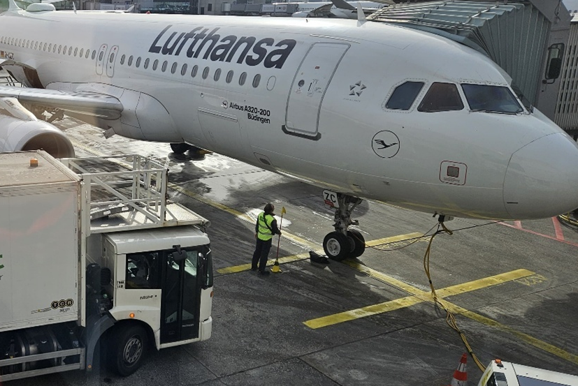 Step 1: A ground crew member stands outside and begins guiding the catering truck with hand signals